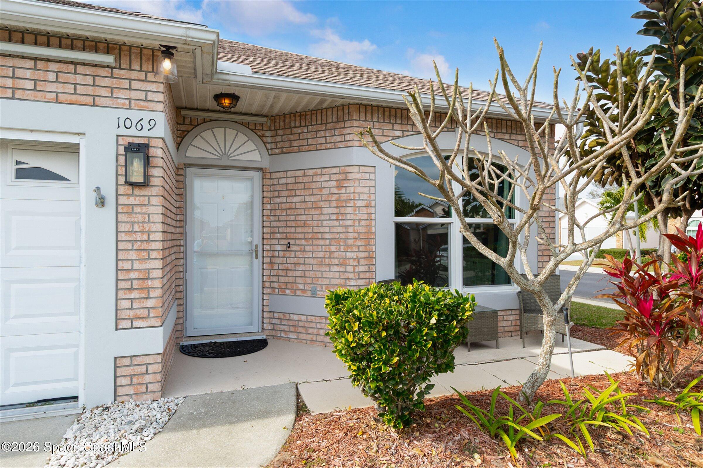 1069 South Fork Circle Melbourne, FL 32901 - Photo 3 of 52 a view of a house with a potted plant and a window