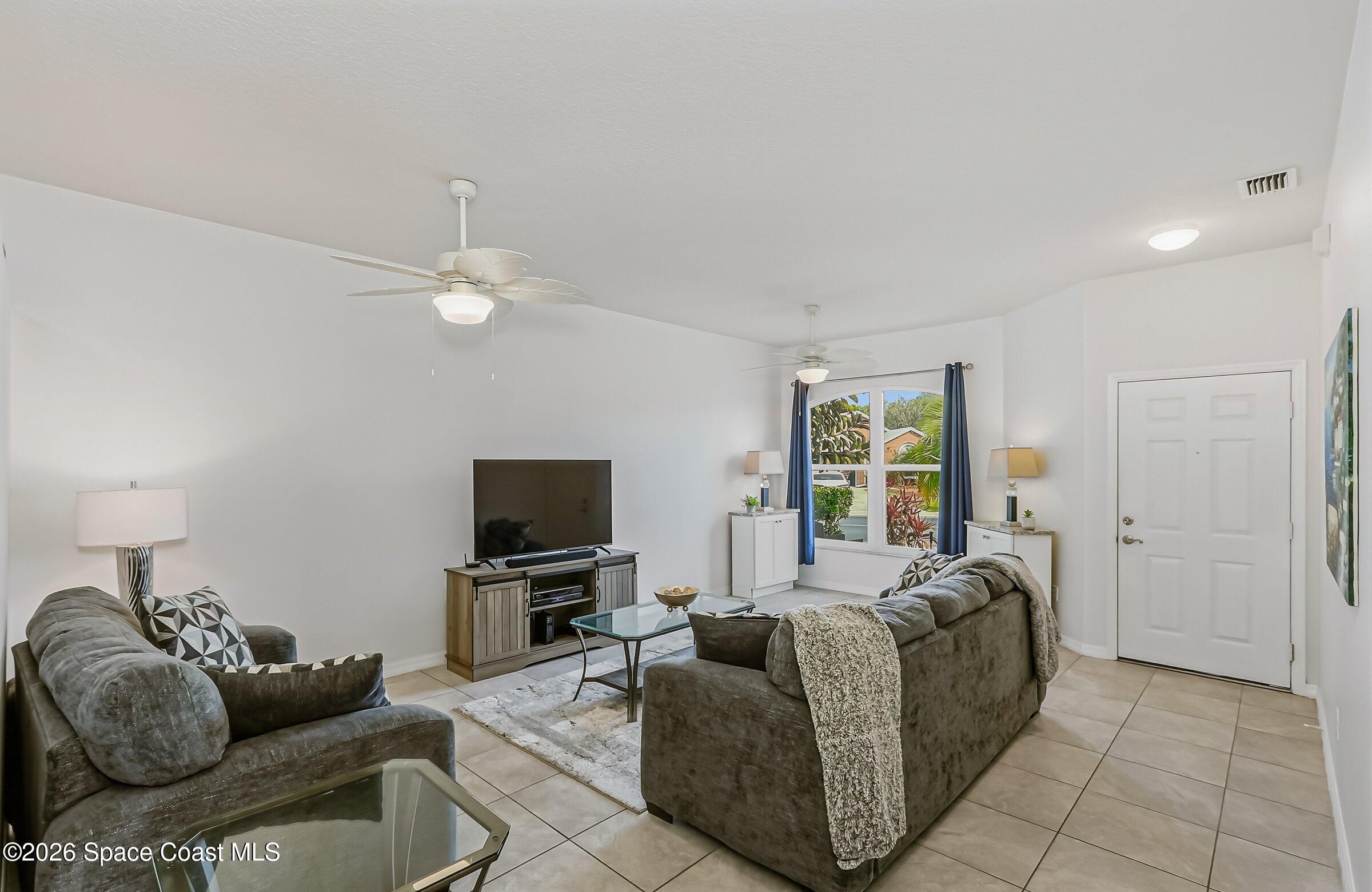 1069 South Fork Circle Melbourne, FL 32901 - Photo 5 of 52 a living room with furniture and a flat screen tv