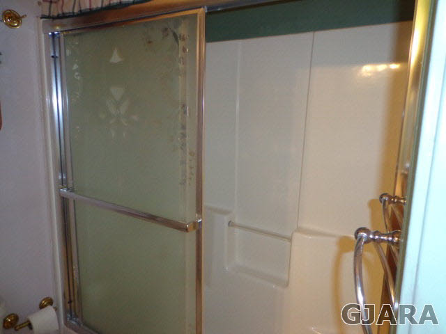 1809 L Road Fruita, CO 81521 - Photo 11 of 19 a bathroom with a glass shower door