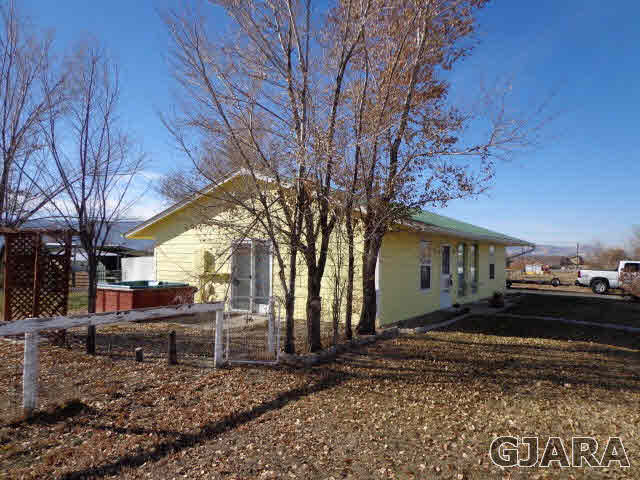 1809 L Road Fruita, CO 81521 - Photo 18 of 19 a front view of a house with a yard
