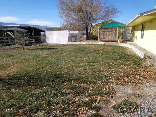 1809 L Road Fruita, CO 81521 - Photo 19 of 19 a view of a house with a yard and garage