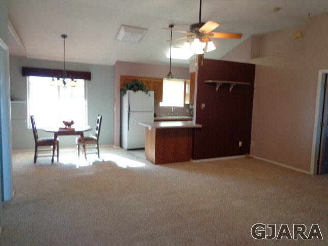 1809 L Road Fruita, CO 81521 - Photo 3 of 19 a living room with furniture and a chandelier