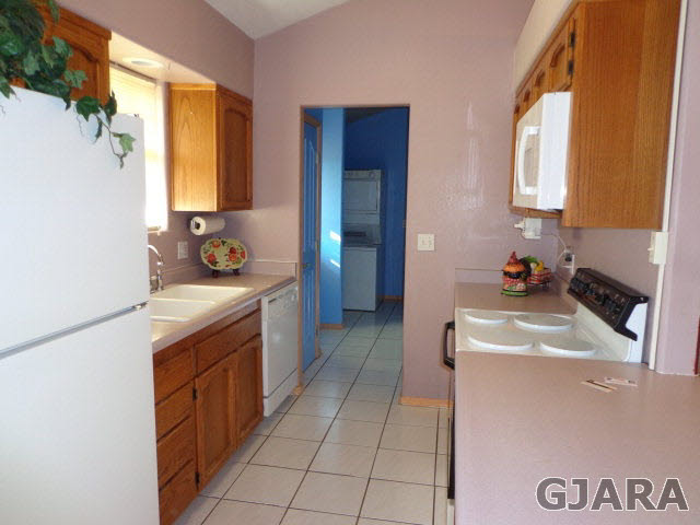 1809 L Road Fruita, CO 81521 - Photo 5 of 19 a kitchen with a sink stove and a refrigerator