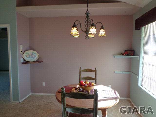 1809 L Road Fruita, CO 81521 - Photo 6 of 19 a view of a dining room with furniture a chandelier and window