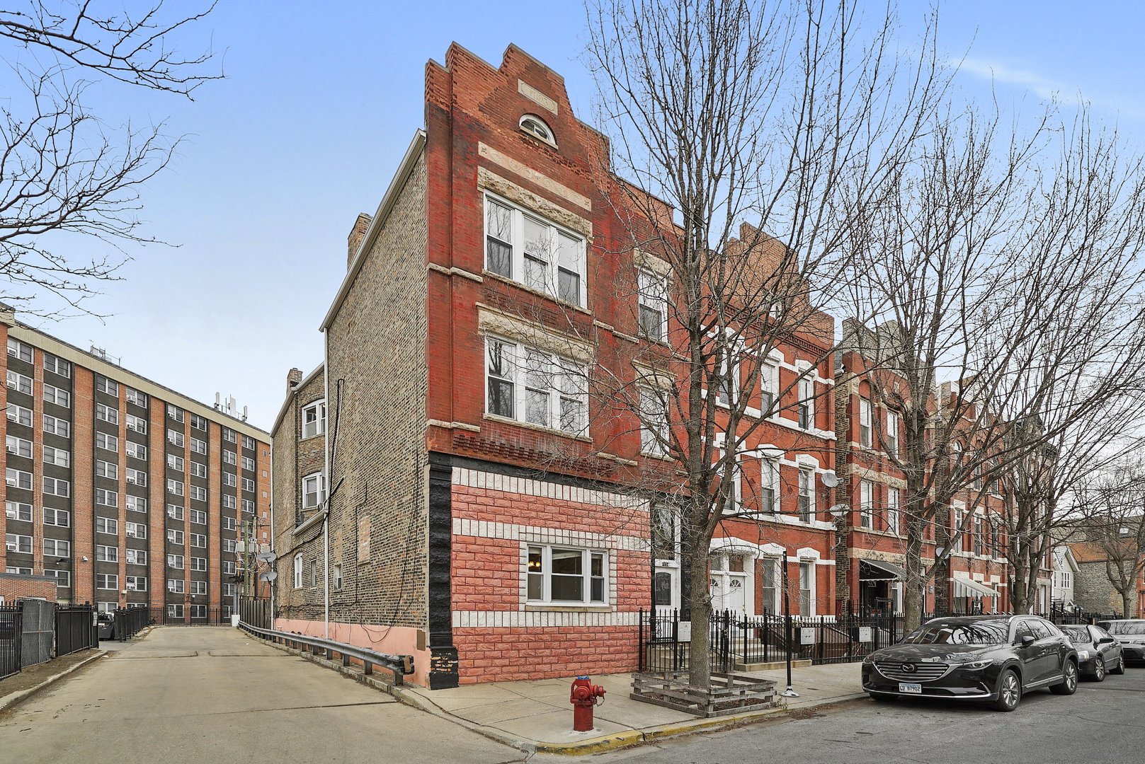 a view of a street that has couple of cars parked on the roadside