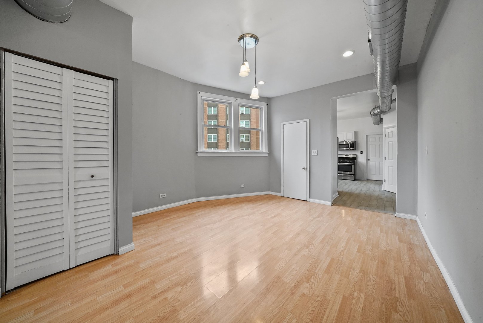 1154 West 17th Street Chicago, IL 60608 - Photo 15 of 35 a view of an empty room with wooden floor and a window