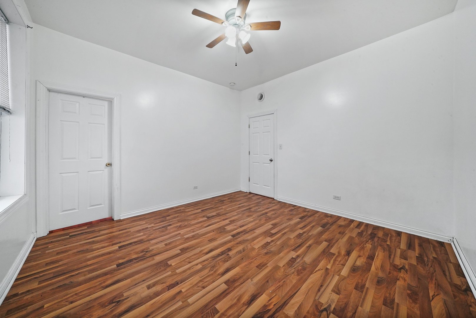 1154 West 17th Street Chicago, IL 60608 - Photo 18 of 35 a view of empty room with window and ceiling fan
