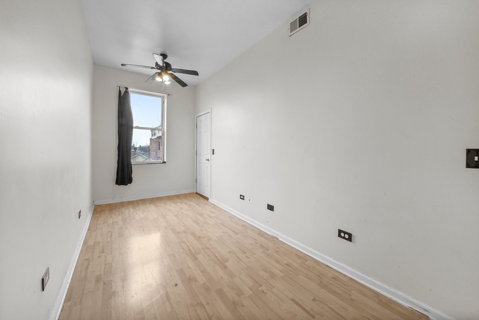 1154 West 17th Street Chicago, IL 60608 - Photo 20 of 35 an empty room with wooden floor chandelier fan and windows