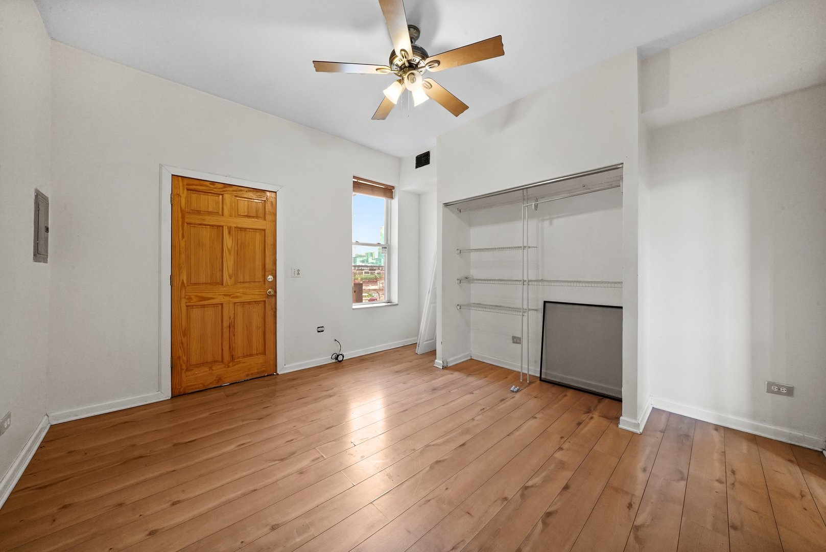 1154 West 17th Street Chicago, IL 60608 - Photo 21 of 35 a view of an empty room with window and wooden floor