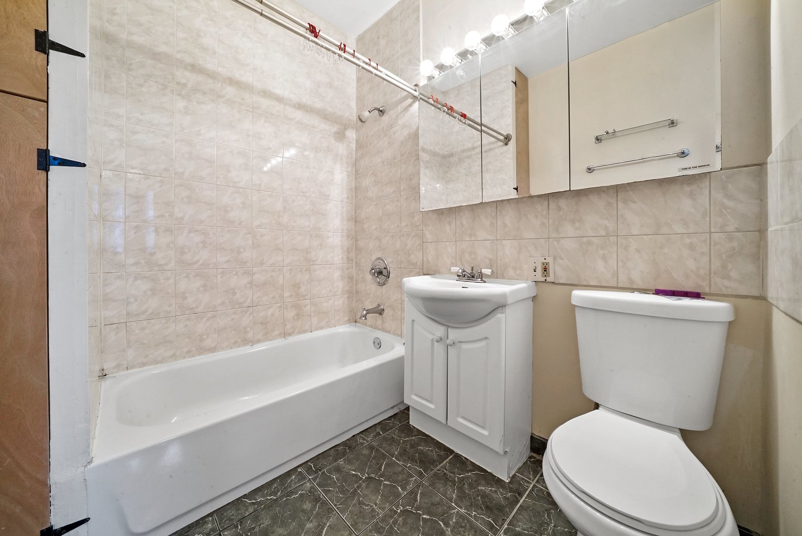 1154 West 17th Street Chicago, IL 60608 - Photo 28 of 35 a white toilet sitting next to a bathtub