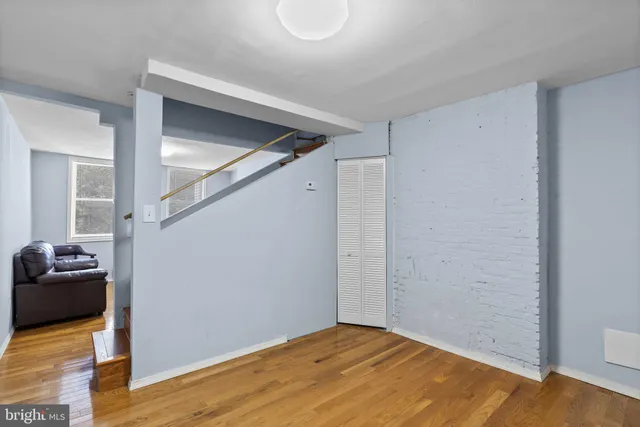 a view of livingroom with hardwood floor and kitchen space