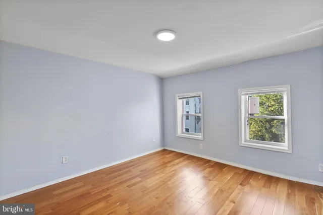 wooden floor in an empty room with a window