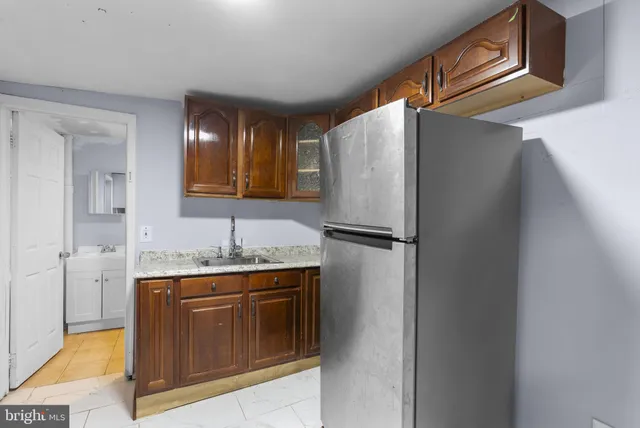 a kitchen with a refrigerator and a sink