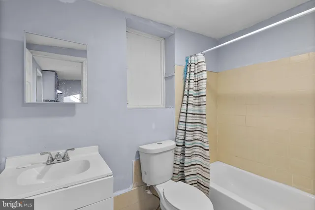 a bathroom with a sink a toilet and a bathtub