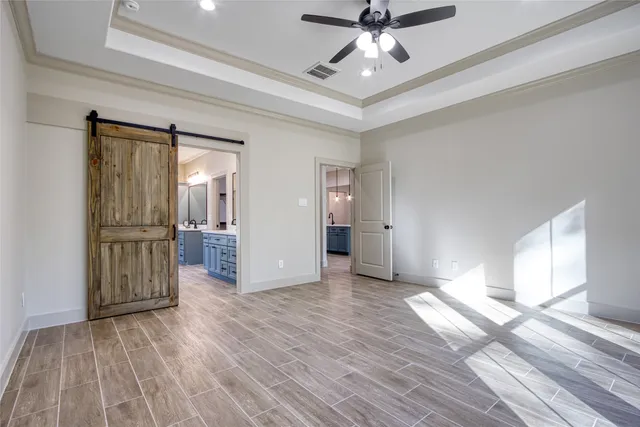a view of a room with wooden floor a ceiling fan and staircase