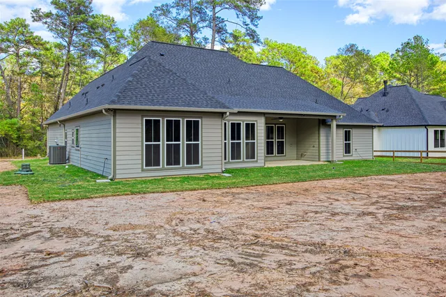 a brick house with a yard and a large tree