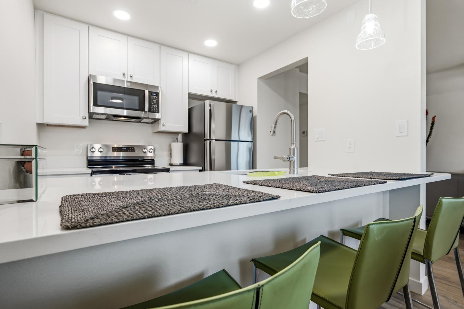 4139 North 27th Street, Unit 2 Phoenix, AZ 85016 - Photo 8 of 31 a kitchen with kitchen island a sink stainless steel appliances and a counter top space