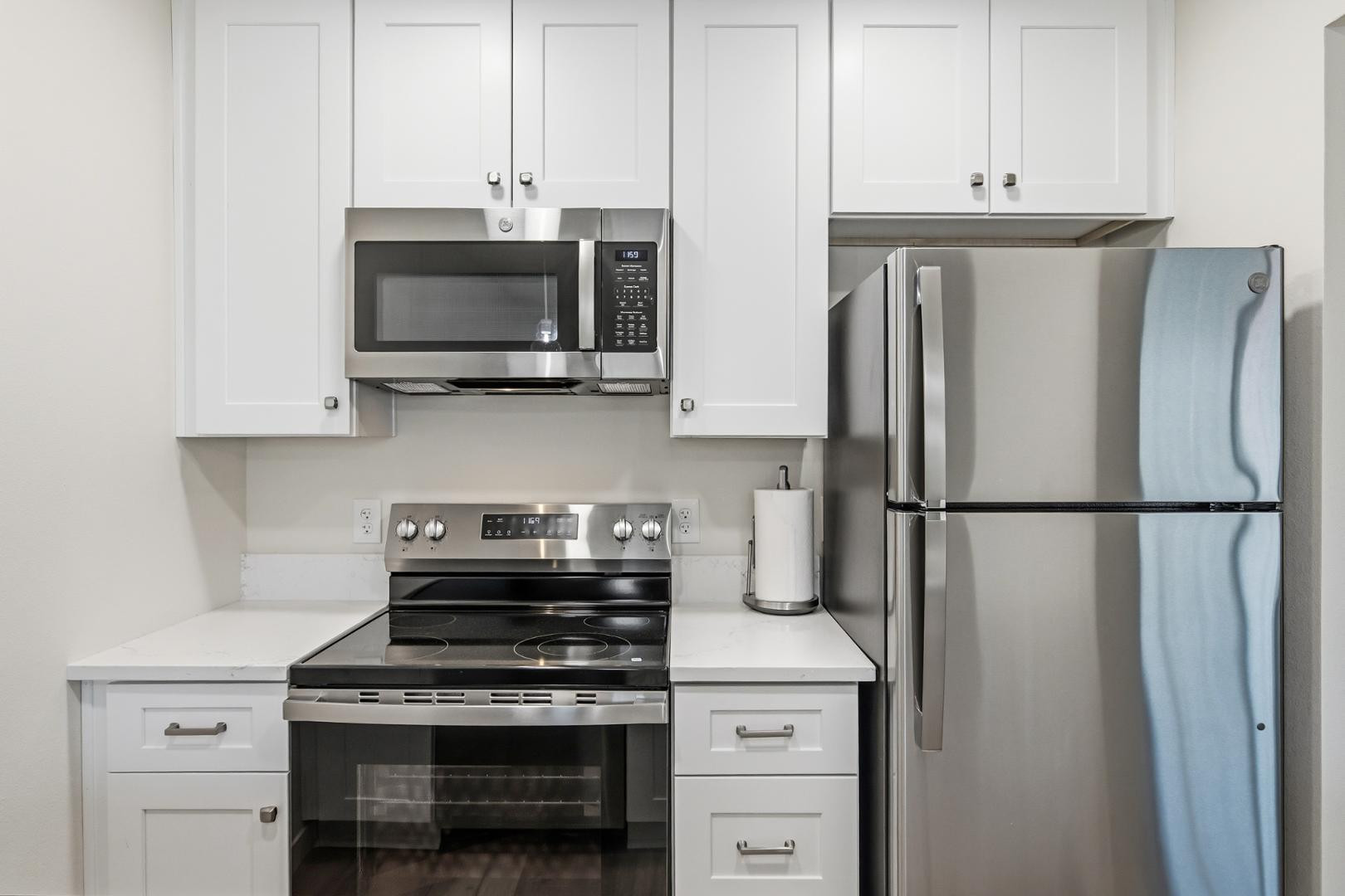 4139 North 27th Street, Unit 2 Phoenix, AZ 85016 - Photo 10 of 31 a kitchen with stainless steel appliances a refrigerator stove and cabinets