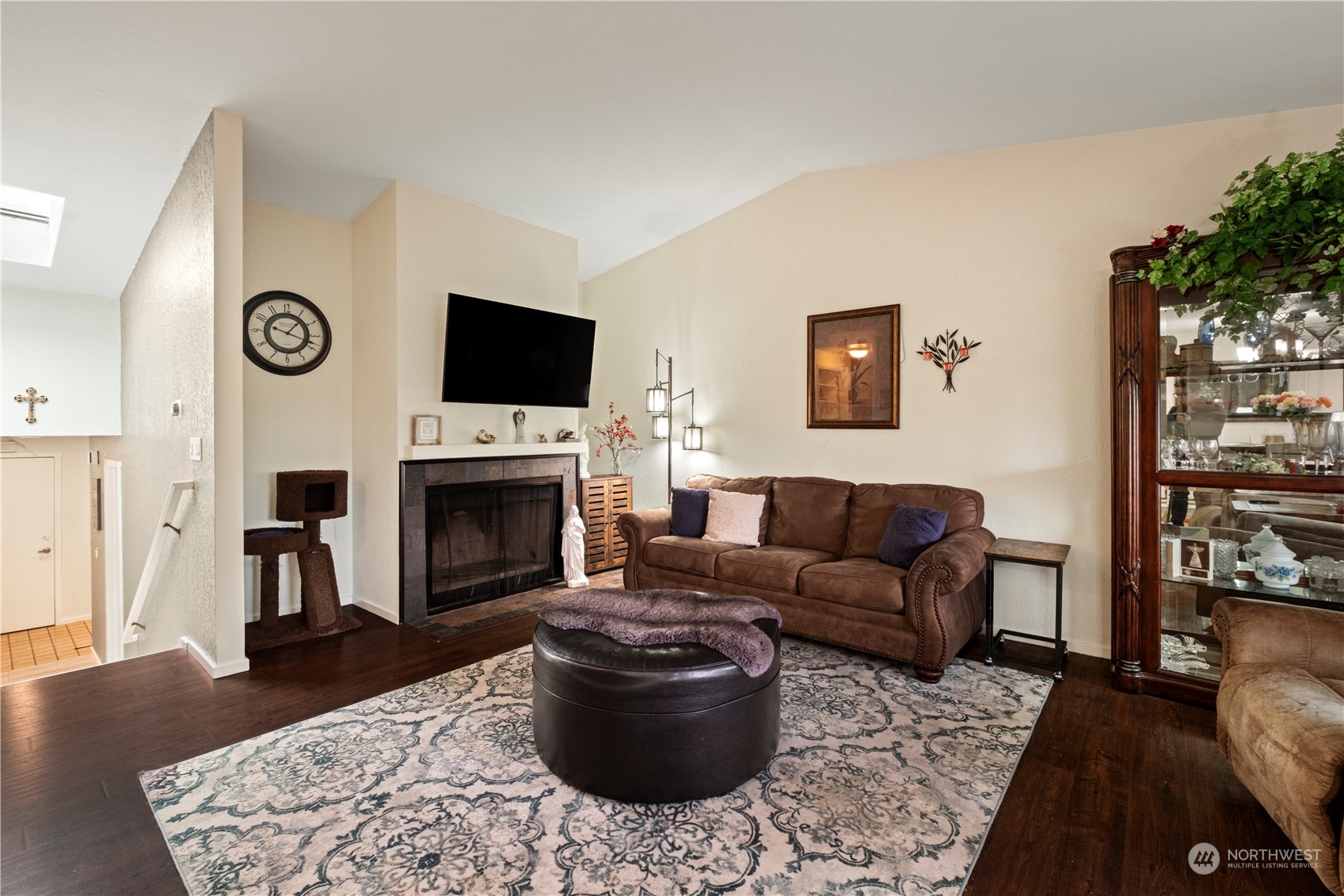 1529 Eagle Ridge Drive South, Unit 1 Renton, WA 98055 - Photo 5 of 26 a living room with furniture a flat screen tv and a fireplace