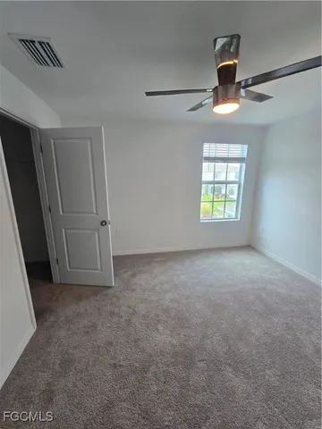 an empty room with windows and closet