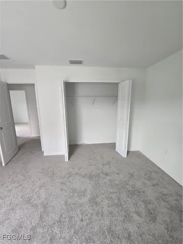 a view of an empty room and entryway