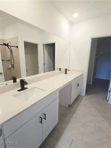 a bathroom with a double vanity sink and mirror