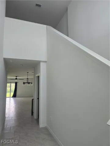 a view of a hallway with two windows