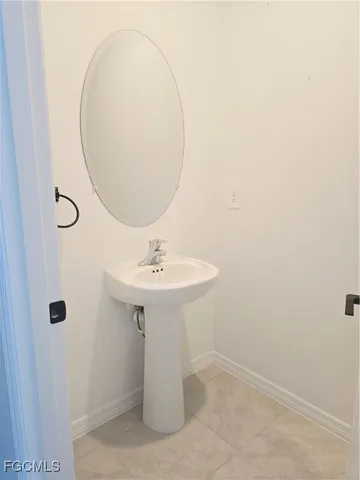 a bathroom with a sink a mirror and a shower