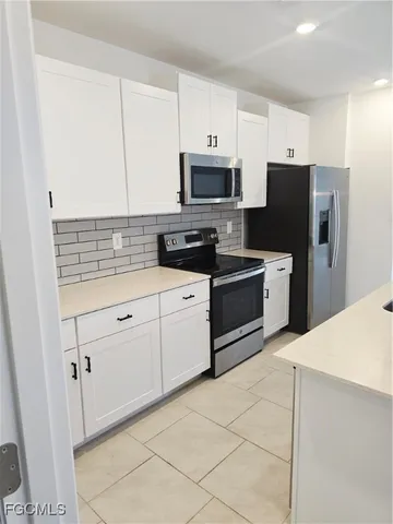 a kitchen with stainless steel appliances a refrigerator sink and cabinets
