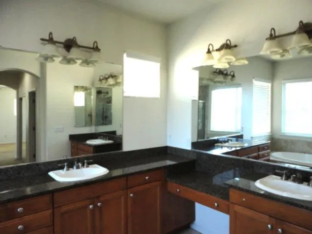 a view of yellow house with flower plants