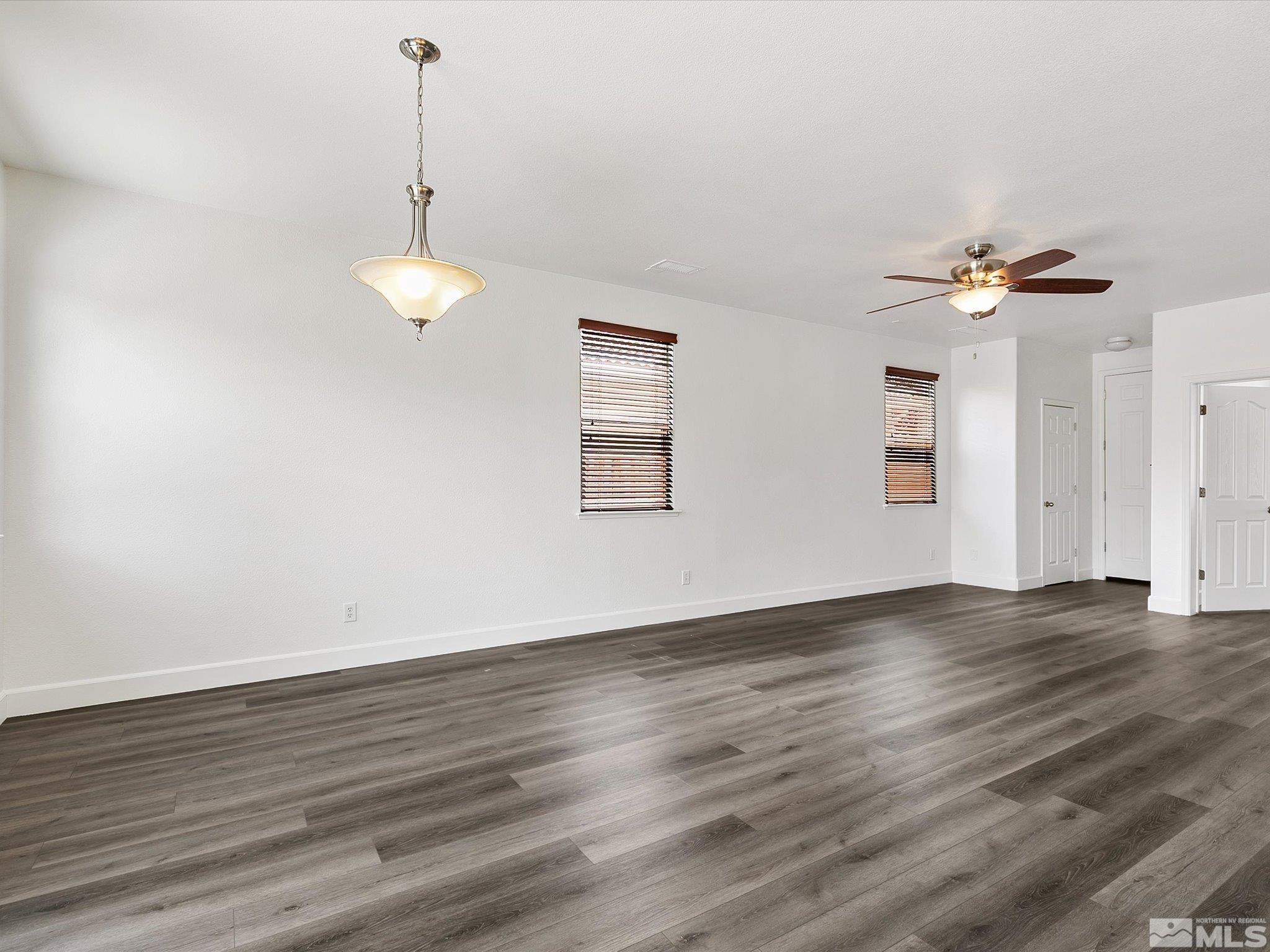 11690 Cervino Drive Reno, NV 89521 - Photo 8 of 31 a view of an empty room with a window and wooden floor