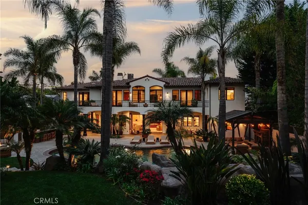 front view of a house with a yard and potted plants