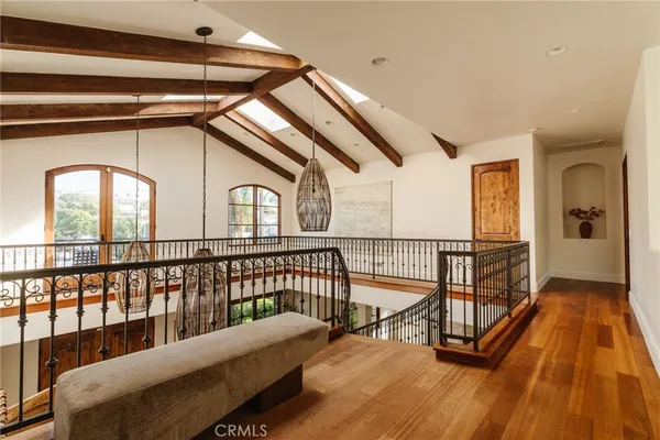 a spacious bedroom with a bed and a chandelier