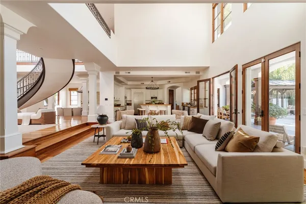 a living room with fireplace furniture and a floor to ceiling window