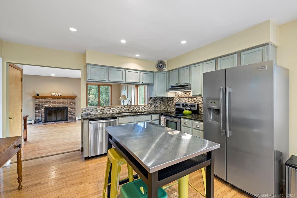 99 Obtuse Road South Brookfield, CT 06804 - Photo 1 of 1 a kitchen with stainless steel appliances granite countertop a refrigerator a stove and a wooden floors