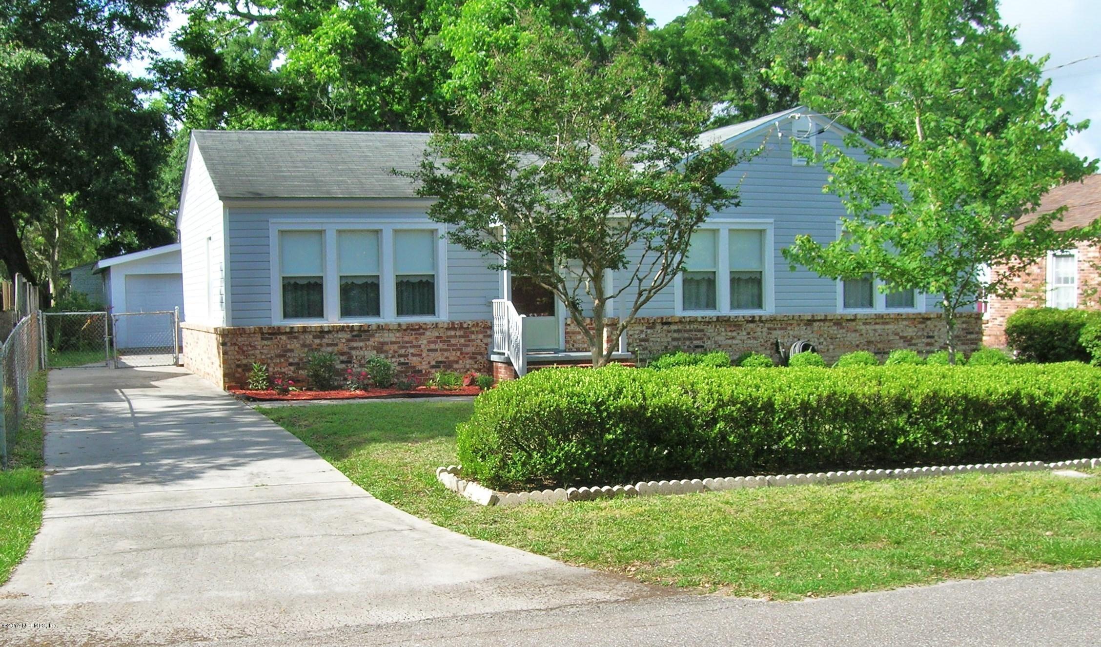 4648 Manchester Road Jacksonville, FL 32210 - Photo 1 of 16 a front view of a house with a yard and potted plants