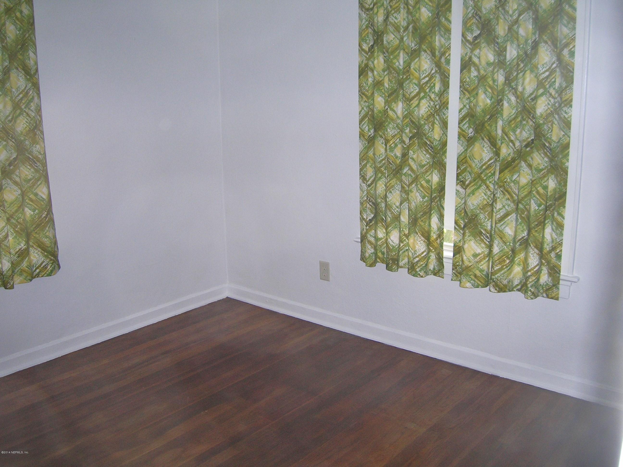 4648 Manchester Road Jacksonville, FL 32210 - Photo 12 of 16 a view of a small space with wooden floor and a window