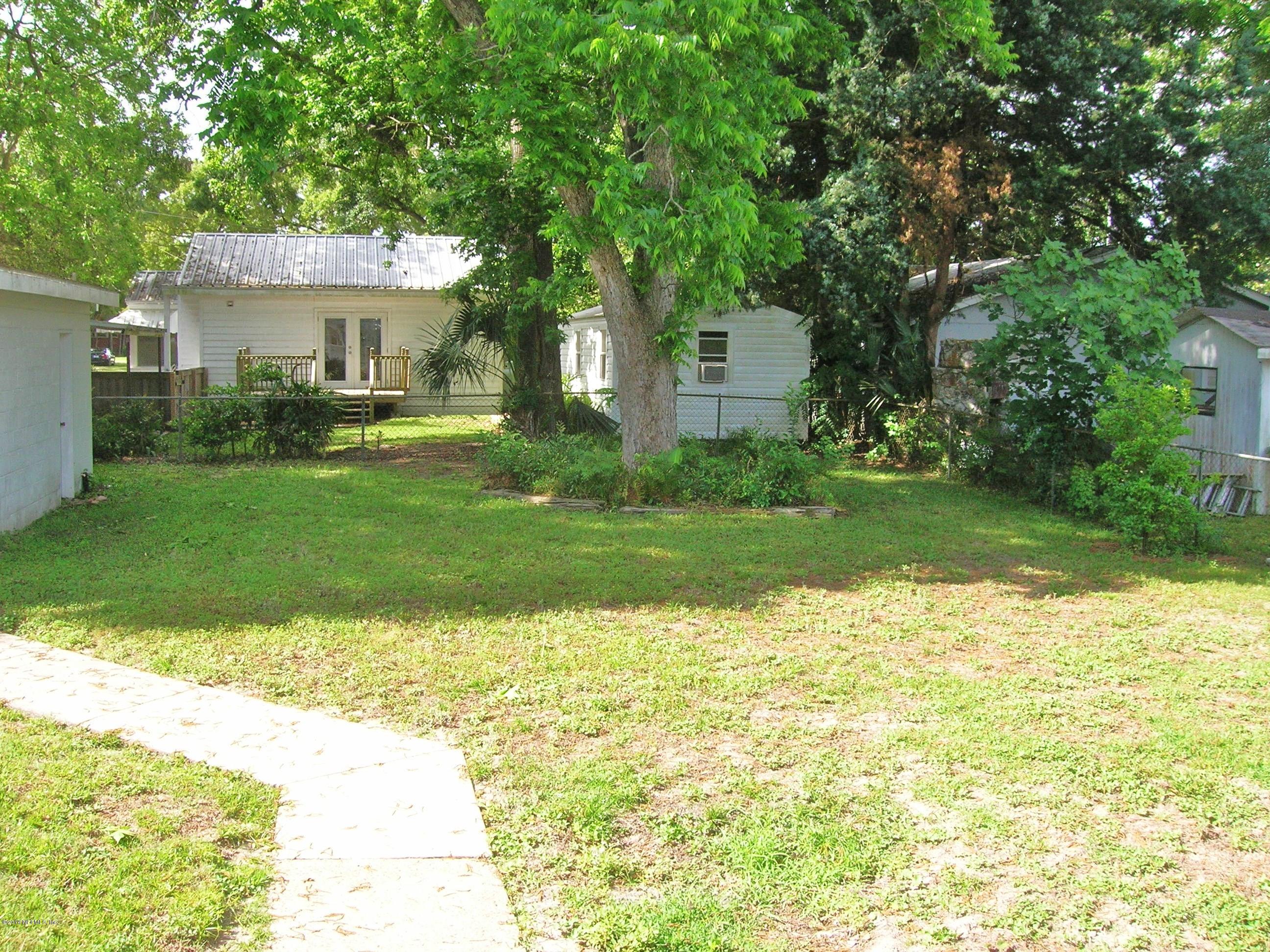 4648 Manchester Road Jacksonville, FL 32210 - Photo 14 of 16 a front view of a house with a yard