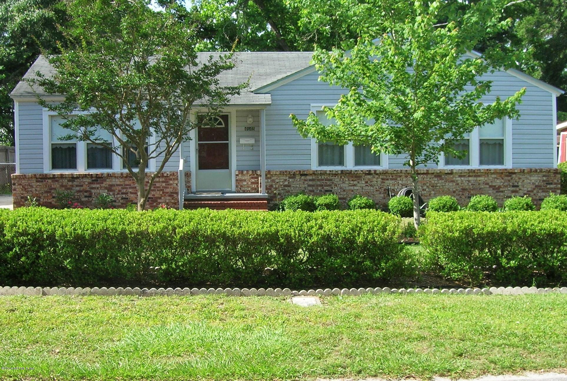 4648 Manchester Road Jacksonville, FL 32210 - Photo 2 of 16 a front view of a house with a garden