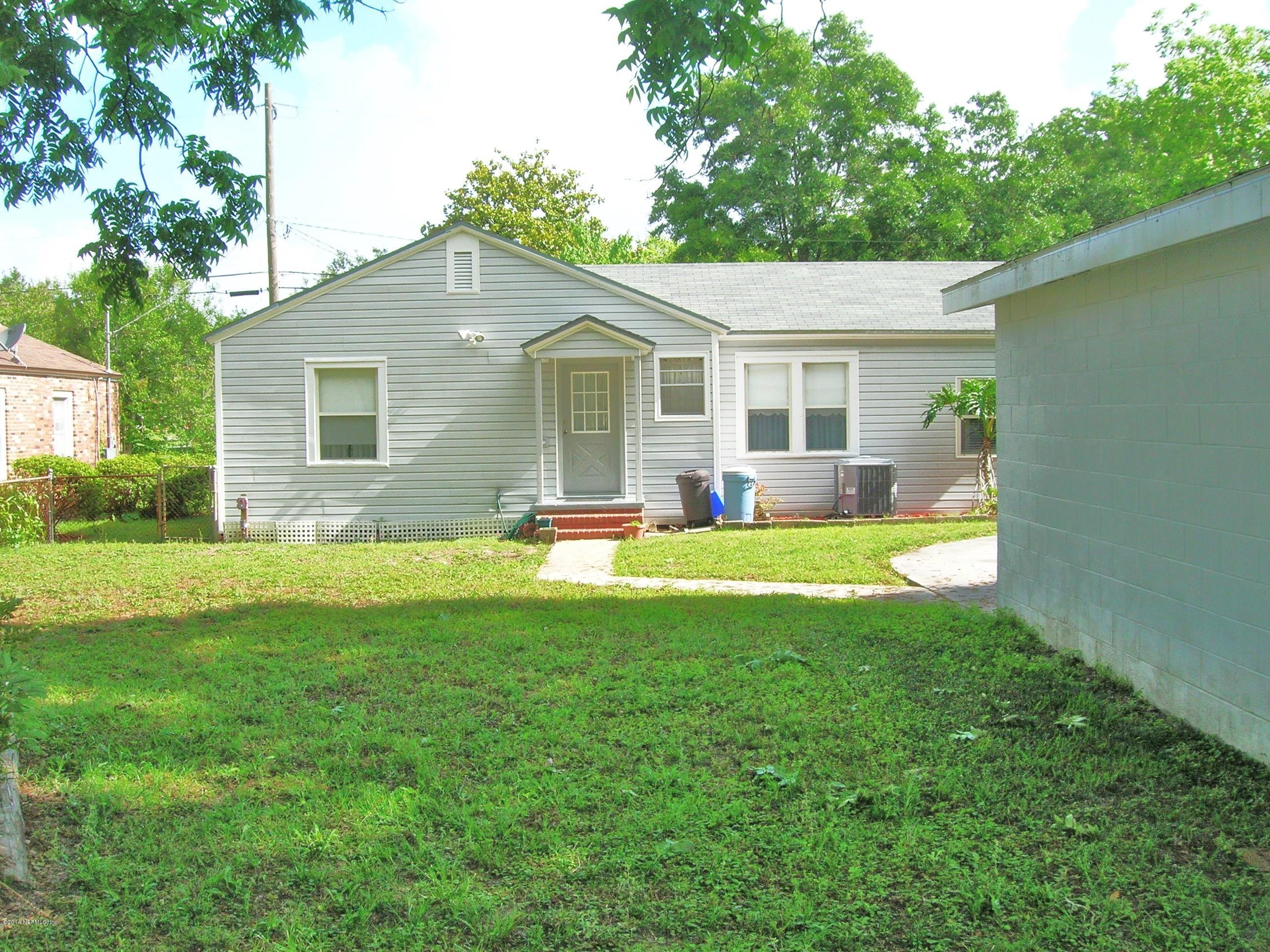 4648 Manchester Road Jacksonville, FL 32210 - Photo 3 of 16 a view of a house with a yard and plants