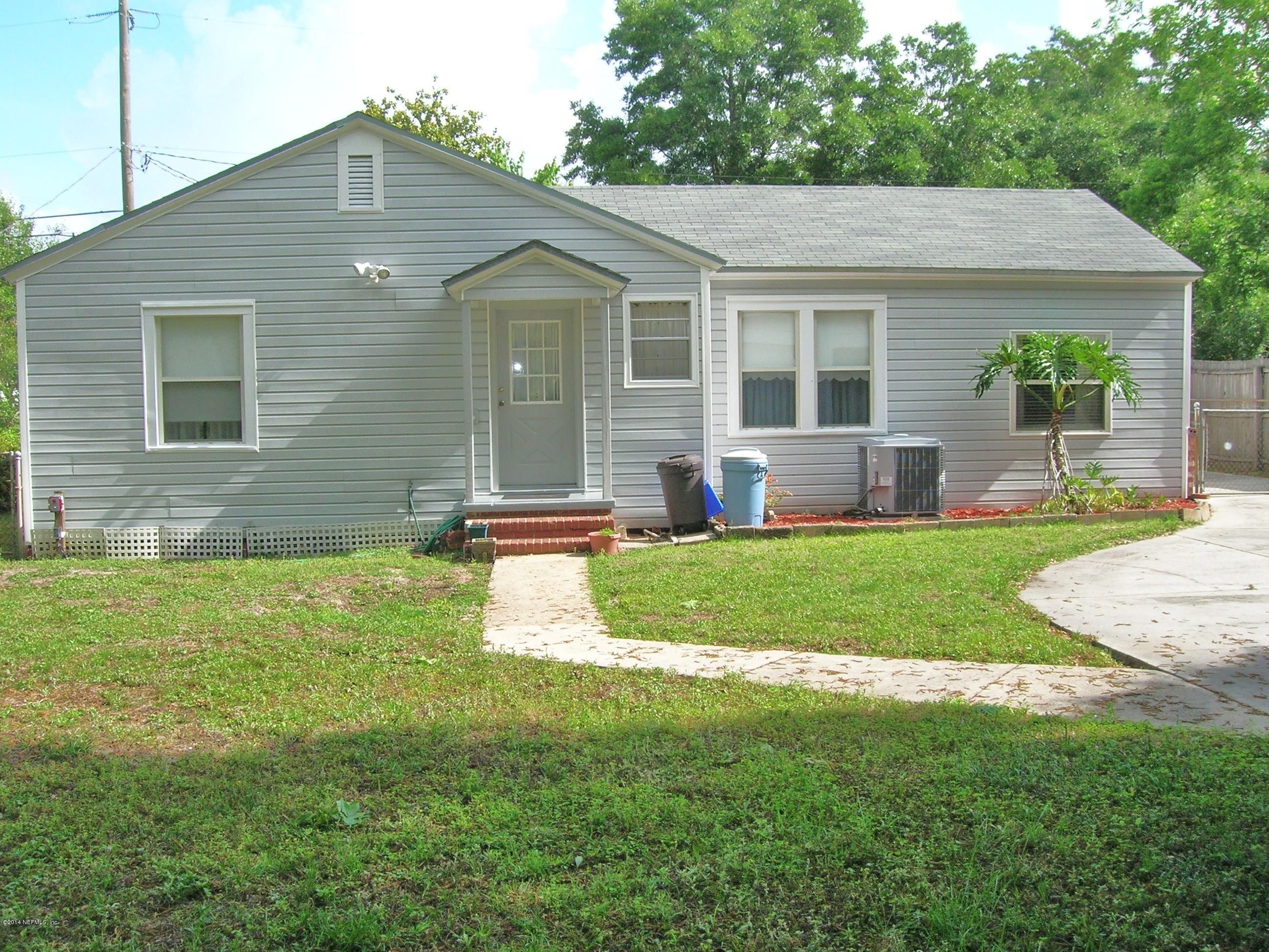 4648 Manchester Road Jacksonville, FL 32210 - Photo 4 of 16 a front view of a house with a yard and porch
