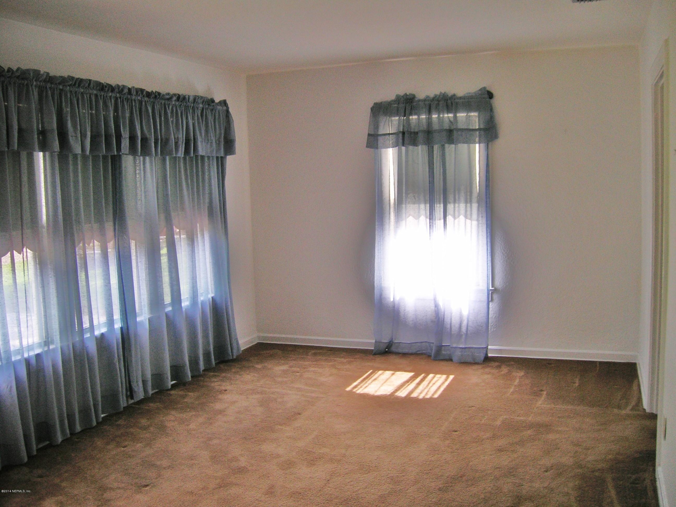 4648 Manchester Road Jacksonville, FL 32210 - Photo 5 of 16 an empty room with windows & yard