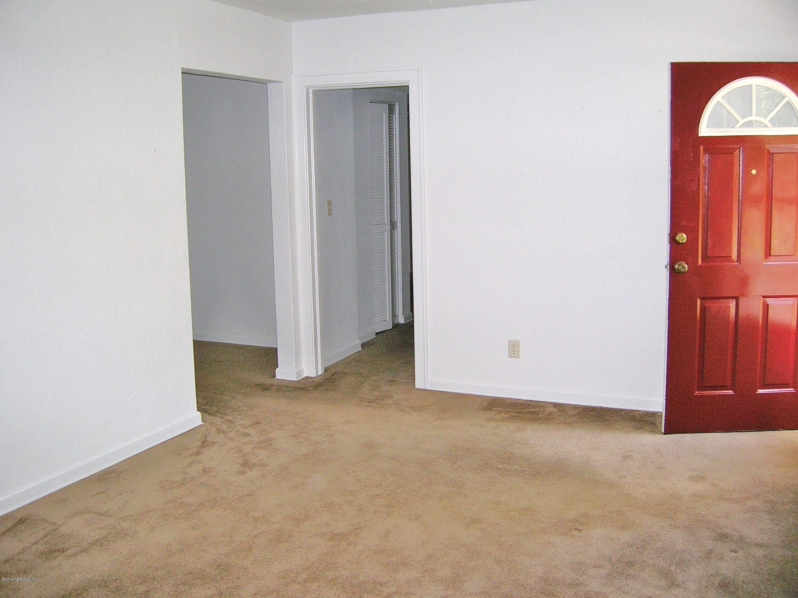 4648 Manchester Road Jacksonville, FL 32210 - Photo 6 of 16 a view of a room with a hallway and closet