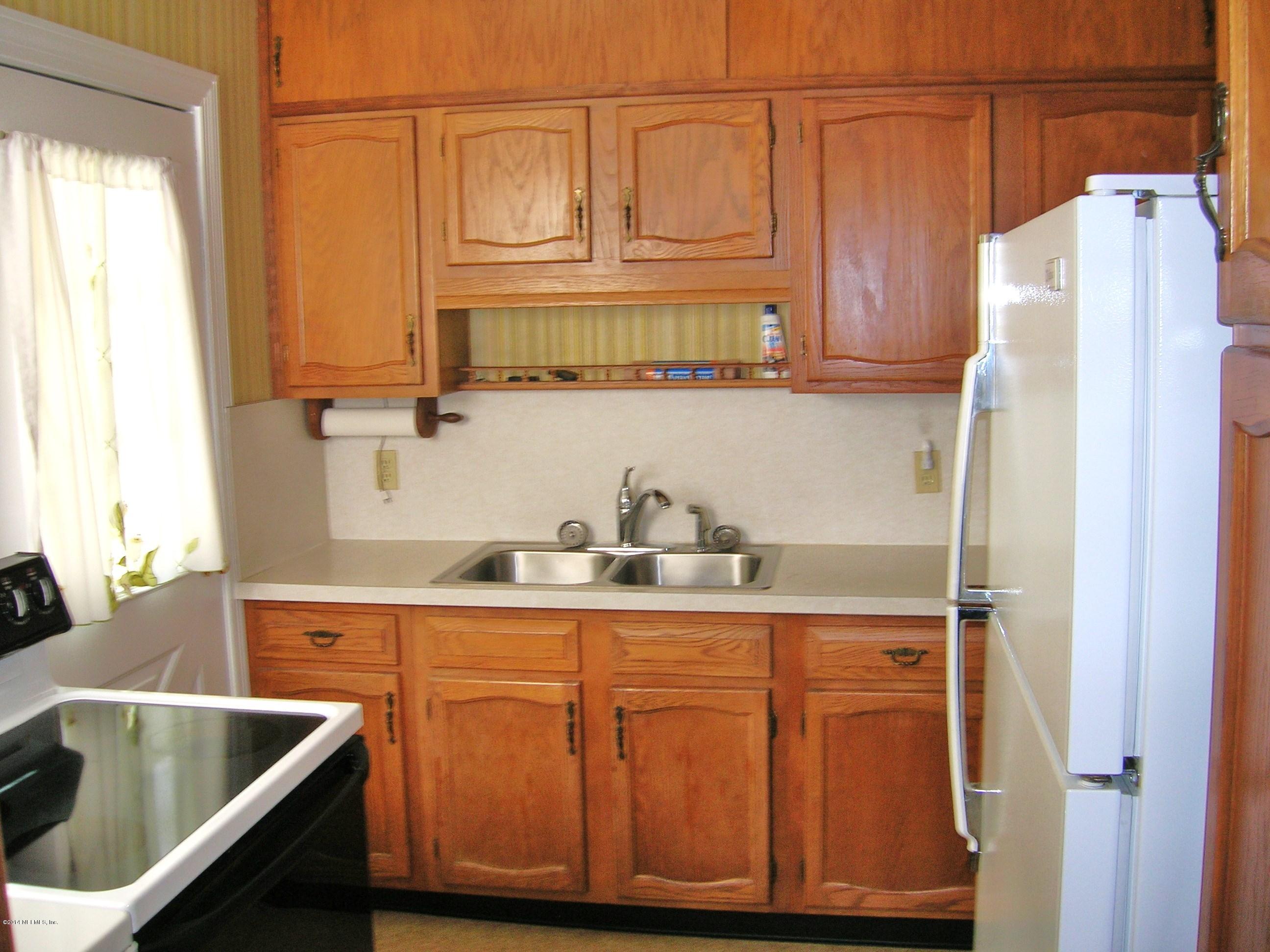 4648 Manchester Road Jacksonville, FL 32210 - Photo 8 of 16 a kitchen with stainless steel appliances granite countertop a sink a refrigerator and a cabinets