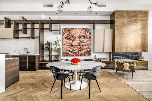 a living room with furniture a rug and a floor to ceiling window
