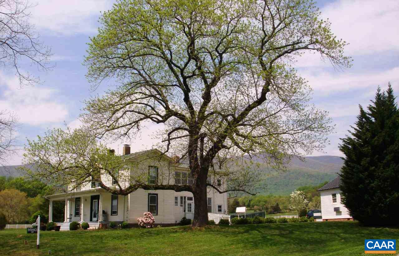 27 Chapel Hollow Road Afton, VA 22920 - Photo 4 of 22 a view of a white house with a big yard and large trees