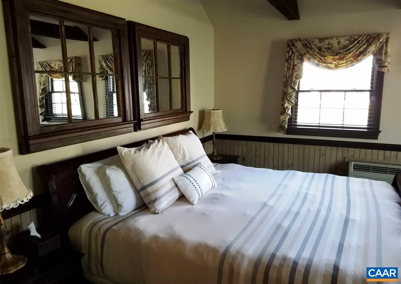 27 Chapel Hollow Road Afton, VA 22920 - Photo 10 of 22 a bed sitting in a bedroom next to a window