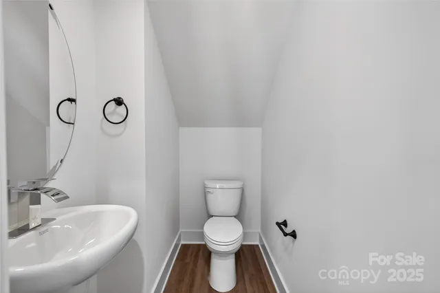 a kitchen with granite countertop a refrigerator stove and sink