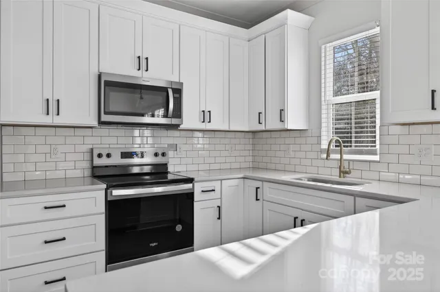 a view of a kitchen with wooden floor and electronic appliances