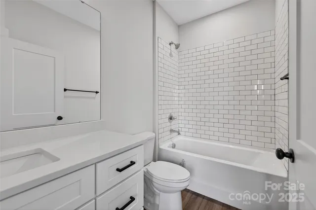 an empty room with wooden floor and mirror